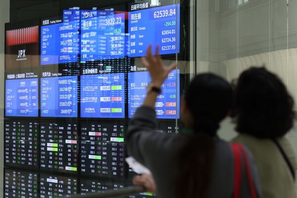 Business analyst reviewing European market trends on multiple screens